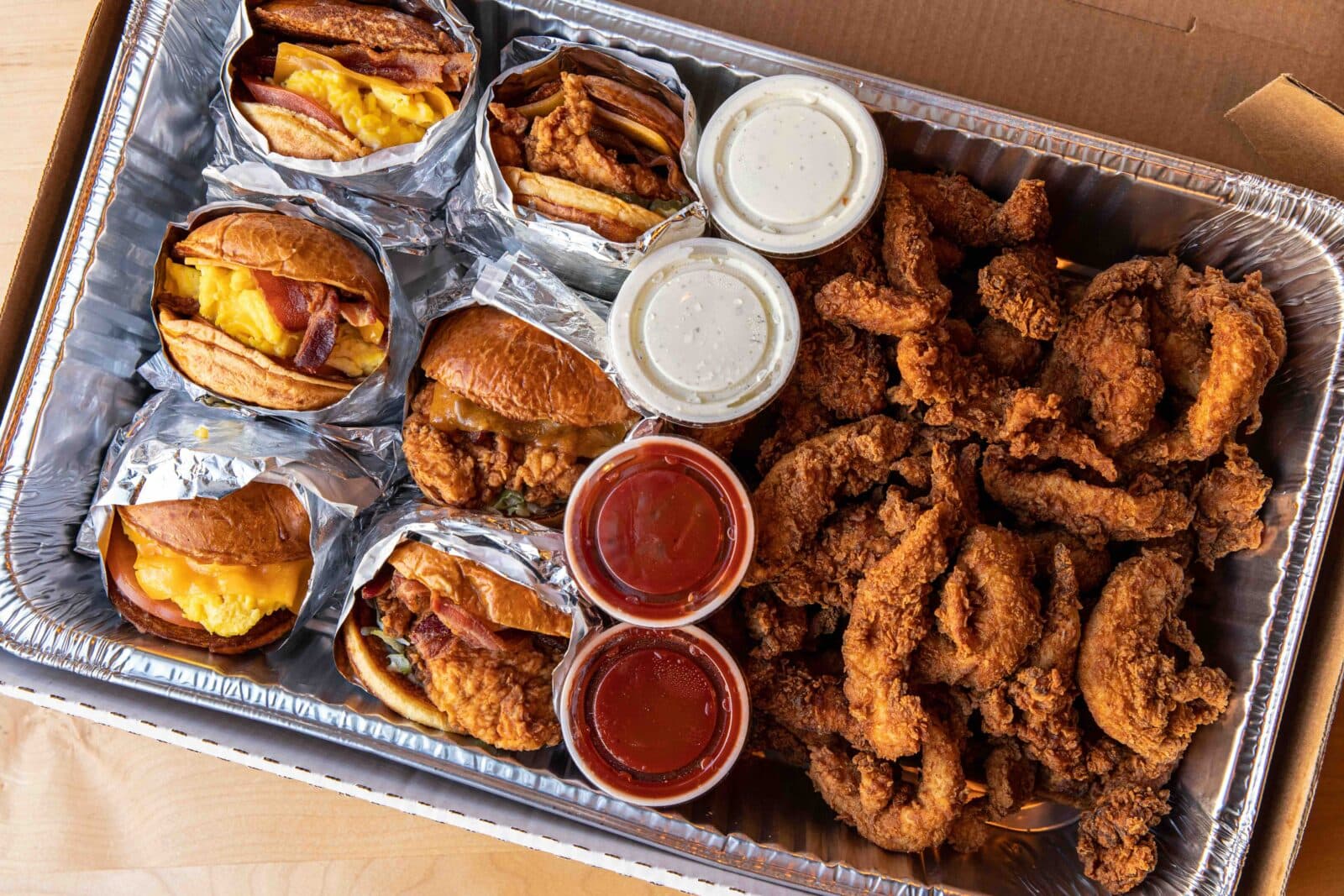 Catering sandwiches and chicken tenders in a pan.